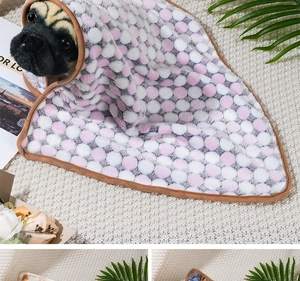 Detail of pink polka dot flannel pet blanket with soft texture and refined brown edging