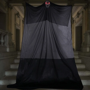 Hanging Halloween ghost with glowing skull and black fabric on castle stairs décor