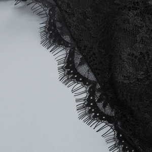 Detailed close-up of premium black eyelash lace fabric with intricate floral embroidery