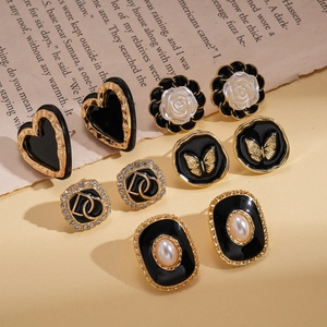 Detailed set of vintage butterfly and heart earrings with gold and black accents