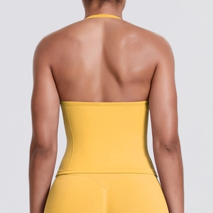 Close-up of bright yellow seamless backless sports top showing racerback and knit texture