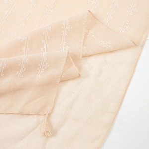 Light orange cotton linen scarf with white geometric patterns and tassel fringe details
