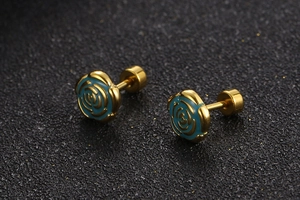 Macro shot of gold plated rose stud earrings with blue enamel petals and screw back detail