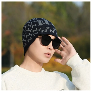 Detail of navy knit beanie with gray NY jacquard pattern for winter outdoor warmth