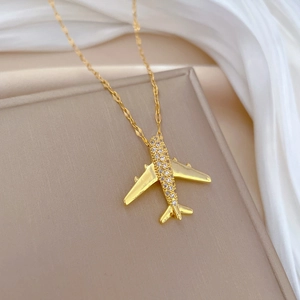 Luxurious gold airplane pendant necklace encrusted with white crystals for women