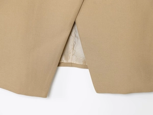 Detail shot of khaki blazer hemline featuring fine stitching and tailored slit design