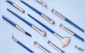 Close-up of 12-piece eye makeup brush set with blue handles and gradient bristles