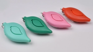 Leaf-shaped personal safety alarms in cyan, green, pink, and orange with keychains