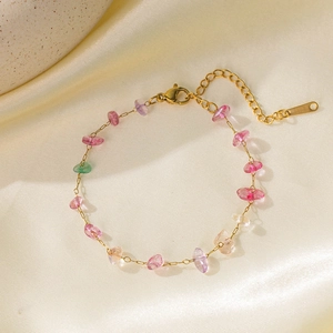 Colorful natural stone beaded bracelet with gold chain and adjustable clasp on silk background