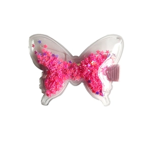 Fermaglio per capelli a farfalla rosa glitterata con paillettes a stella bimba