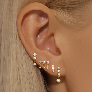 Detailed close-up of a five-piece gold earring set with sparkling white cubic zirconia
