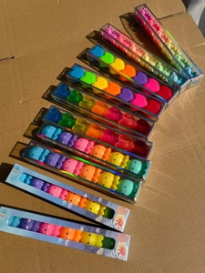 Close-up of colorful heart and octopus shaped mini erasers in transparent gift boxes