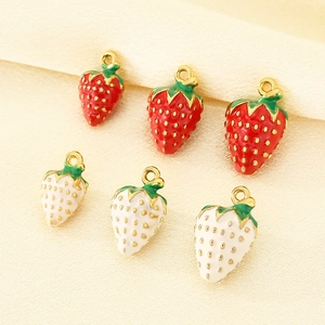 Detail of 3D 304 stainless steel strawberry charms in red and white with gold accents