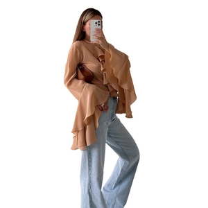 Women's ruffle chiffon blouse with flared sleeves in khaki, paired with denim jeans