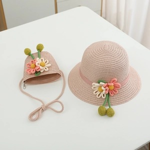Detail of pink woven straw hat and crossbody bag set with 3D floral decorations