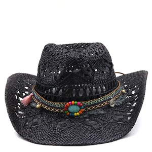 Detail of black straw cowboy hat featuring ethnic ribbon, turquoise stone and tassels