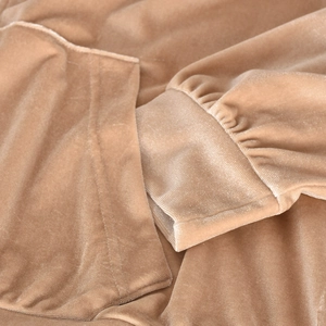Detail of velvet hoodie cuff and pocket texture in khaki with soft fabric sheen
