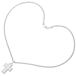 Macro shot of silver cross pendant with clear cubic zirconia in heart chain layout