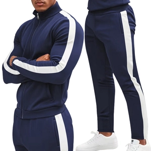 Detailed close-up of navy tracksuit with contrast white stripes on sleeves and pants