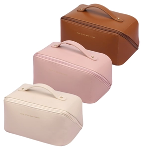 Large capacity leather travel cosmetic bags in brown, pink, and off-white with gold logo