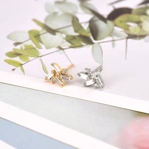 Irregular starburst geometric stud earrings with baguette zircons in gold and silver