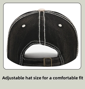 Close-up of washed gray denim baseball cap back with bronze metal buckle and contrast stitching
