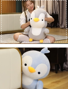 Close-up of soft plush penguin pillows in grey and blue for home comfort and hugging