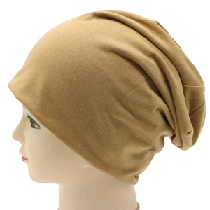 Detail of khaki slouchy knit beanie showing soft cotton fabric texture on model side view