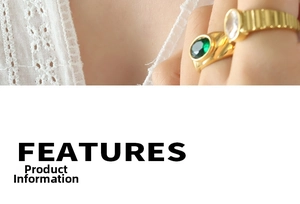 Close-up of gold plated ring set featuring an oval green gemstone and striped band