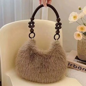 Detail of faux fur tote bag showing plush brown texture and beaded bohemian handle