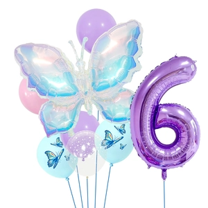 Detail of laser butterfly and purple number 6 foil balloons for a girl birthday party setup