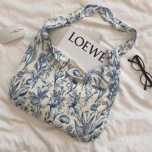 Detail view of cotton tote with blue floral Toile de Jouy print and snap button closure
