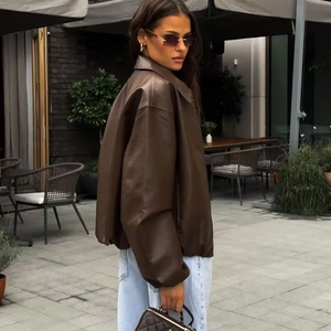 Detail view of oversized dark brown faux leather jacket with high street fashion styling