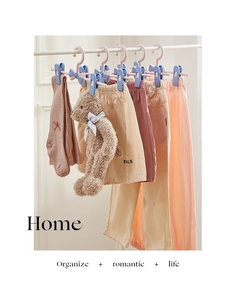 Adjustable kids hangers drying pants and socks with clips in a home setting