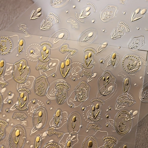 3D gold embossed tulip nail art stickers with elegant floral and letter designs