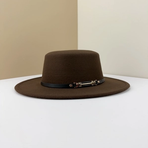 Detail of dark brown wide-brim felt hat with black leather strap and gold metal buckle
