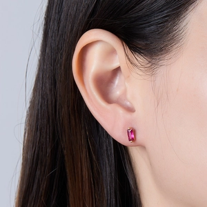 Close-up of rectangle emerald-cut pink zircon stud earring in gold-plated silver