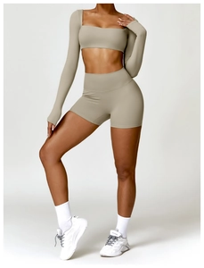 Detail of light brown long sleeve yoga top and high waist shorts set on a model