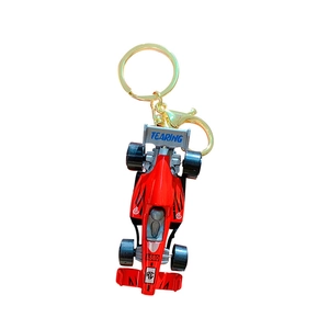 Mini red F1 racing car model keychain with golden metal ring on white background