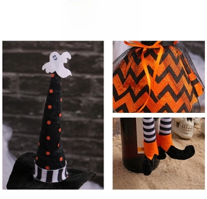 Detail view of Halloween witch wine bottle cover with ghost hat and striped legs