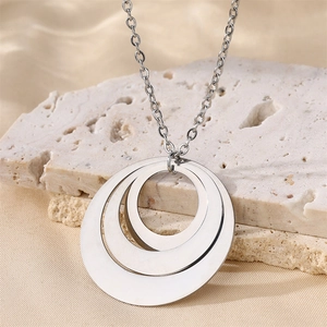 Minimalist stainless steel interlocking triple ring pendant necklace on a stone base
