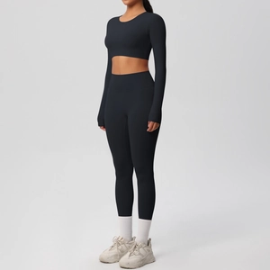 Side view of black long-sleeve crop top and high-waisted yoga leggings set for fitness