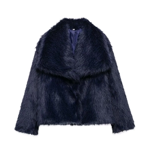 Detailed view of plush navy blue faux fur coat featuring wide lapels and soft texture