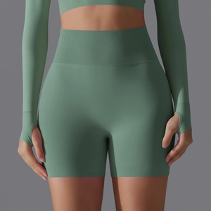 Detail of high-waisted seamless yoga shorts with ribbed waistband in sage green fabric