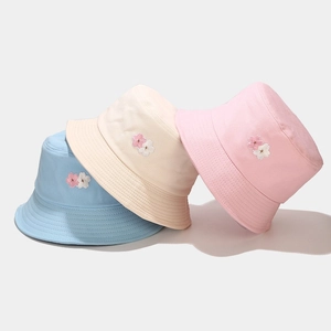 Cotton bucket hats with cherry blossom embroidery in light blue, beige, and pink