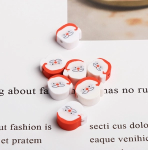 Detailed view of red and white Santa Claus polymer clay beads for DIY jewelry making