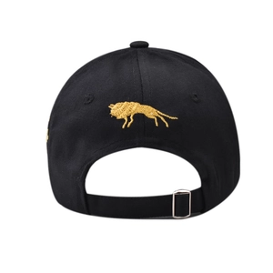 Detail view of the back of a black cotton baseball cap with golden wolf embroidery and buckle
