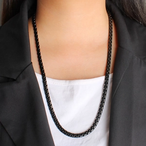 Close-up of 4mm black stainless steel box chain necklace worn by a model