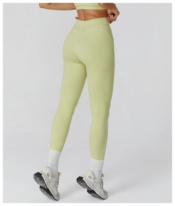 Detail of high-waist light green yoga leggings with back butt-lifting seam design
