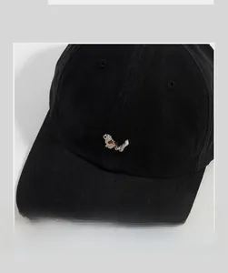Close-up of cute Corgi dog embroidery on black cotton twill baseball cap fabric
